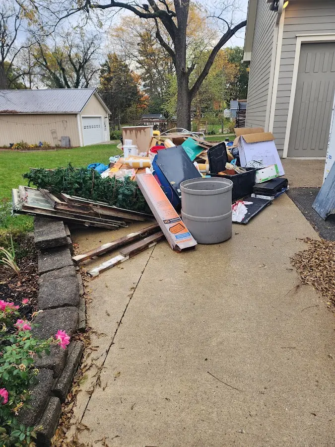 Dumpster being loaded with debris for Commercial Dumpster Rental in Council Bluffs